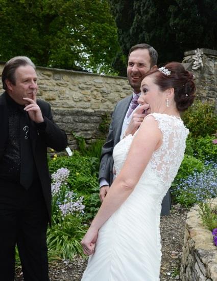 Wedding Magician performing close-up magic for a bride.